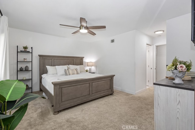 bedroom with a closet, light colored carpet, and ceiling fan