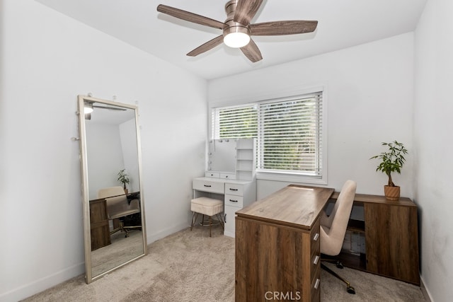 carpeted home office featuring ceiling fan