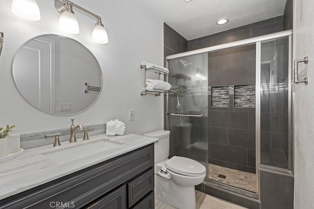 bathroom featuring an enclosed shower, vanity, and toilet