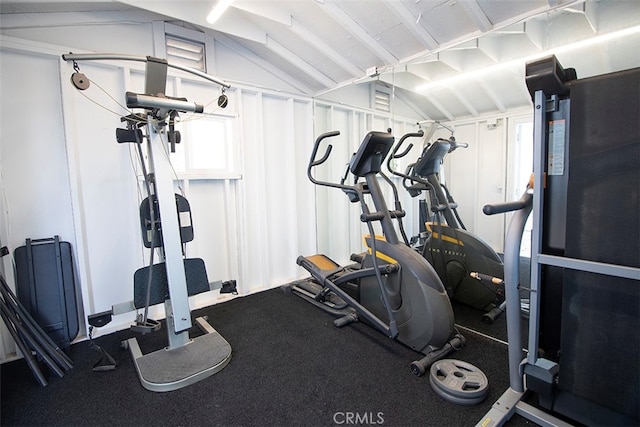 workout room with vaulted ceiling