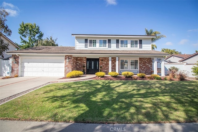 view of front facade with a garage and a front lawn