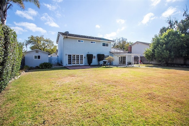 back of house featuring a lawn, a pergola, a patio area, and french doors