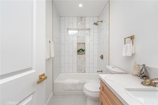 full bathroom featuring tiled shower / bath, vanity, tile patterned floors, and toilet