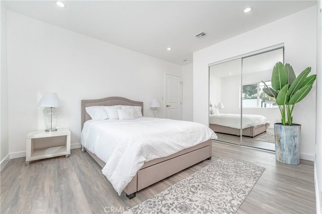 bedroom featuring hardwood / wood-style flooring and a closet