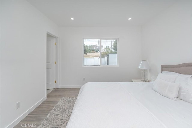 bedroom with hardwood / wood-style floors