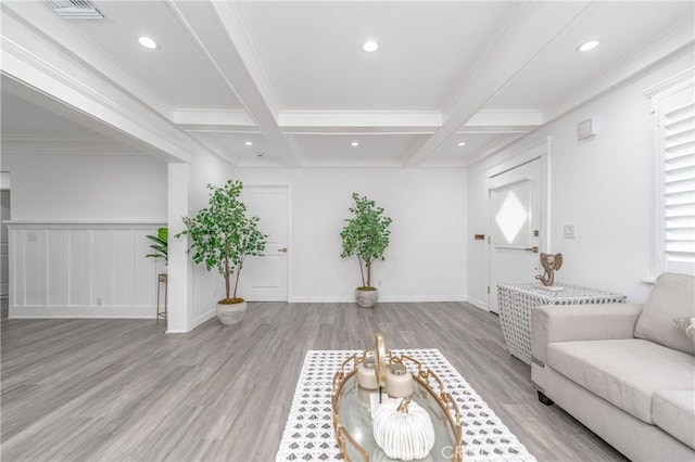 living room with coffered ceiling, beam ceiling, light hardwood / wood-style flooring, and ornamental molding