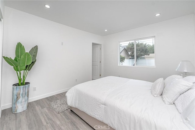 bedroom with hardwood / wood-style flooring