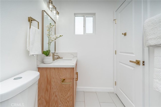 bathroom with tile patterned floors, vanity, and toilet