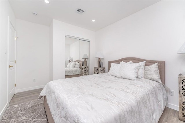 bedroom with hardwood / wood-style floors and a closet