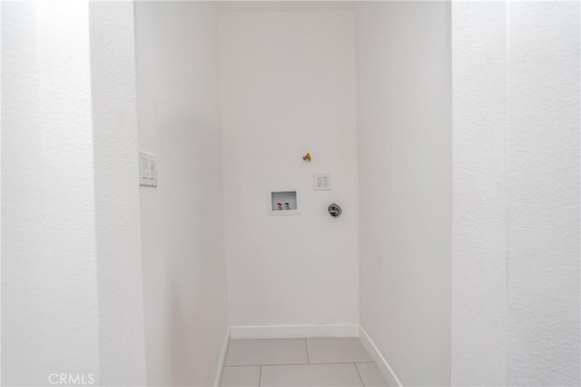 washroom featuring hookup for a washing machine and light tile patterned floors