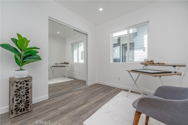 living area with hardwood / wood-style flooring