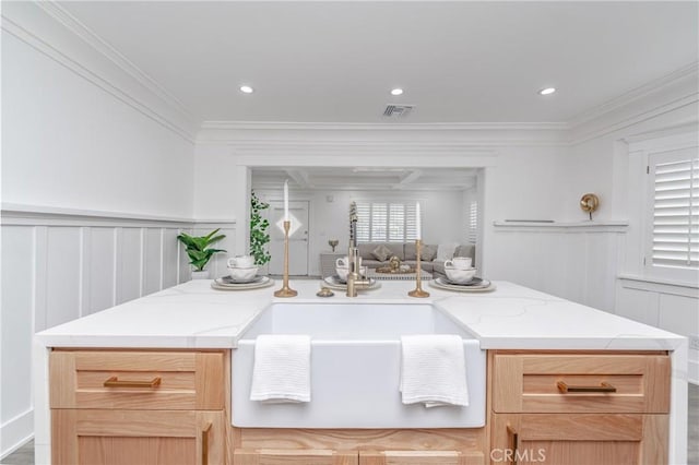 kitchen featuring ornamental molding and light brown cabinets