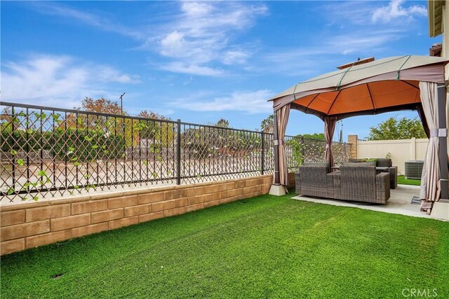 view of yard with an outdoor living space, a gazebo, and central air condition unit