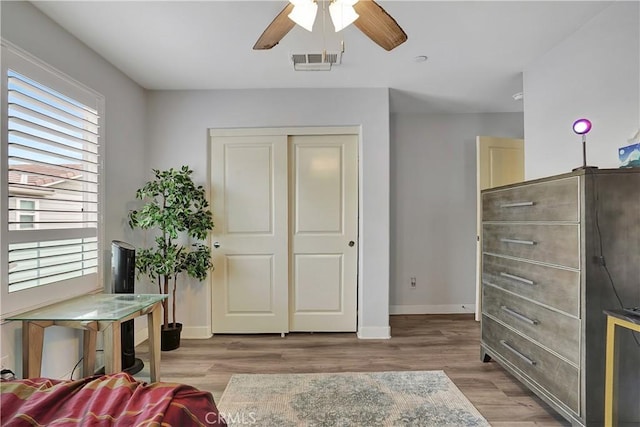 living area featuring ceiling fan and light wood-type flooring