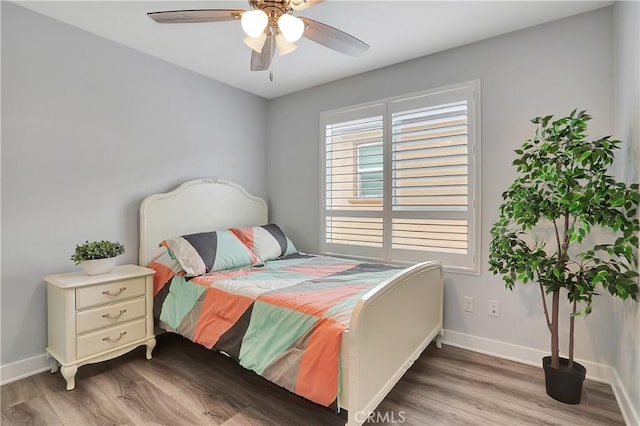 bedroom with hardwood / wood-style floors and ceiling fan