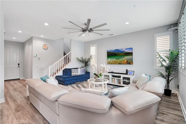 living room featuring ceiling fan and light hardwood / wood-style floors