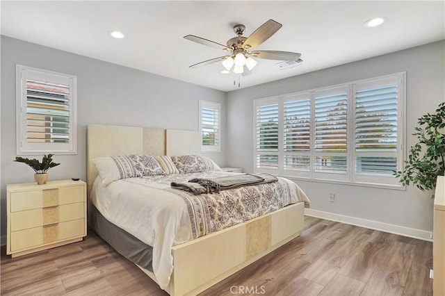 bedroom featuring hardwood / wood-style flooring and ceiling fan