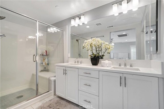 bathroom featuring vanity and a shower with door