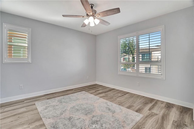 spare room with ceiling fan and light hardwood / wood-style flooring