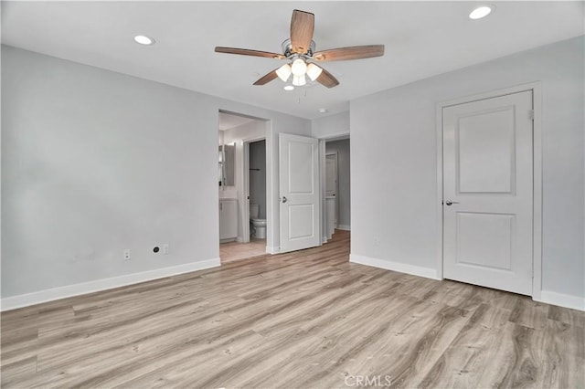 unfurnished bedroom with ceiling fan, ensuite bath, and light hardwood / wood-style flooring