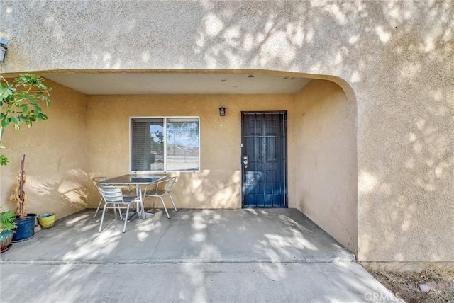 entrance to property featuring a patio area