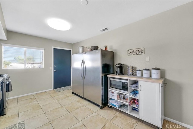 kitchen featuring light tile patterned floors and appliances with stainless steel finishes