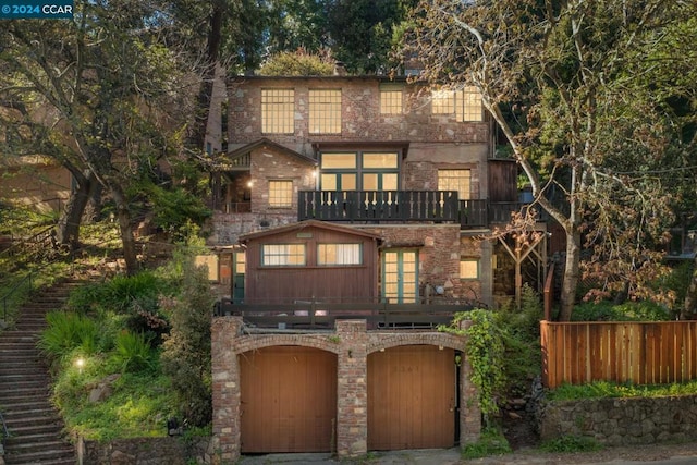 view of front of home with a balcony and a garage