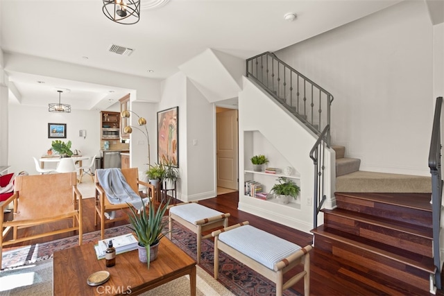 living room featuring hardwood / wood-style flooring and a chandelier