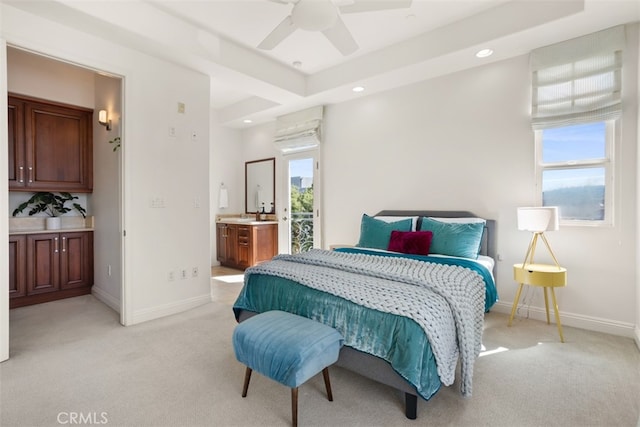 bedroom with ensuite bathroom, ceiling fan, and light colored carpet