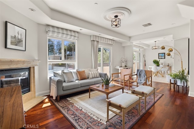 living room featuring dark hardwood / wood-style flooring and a chandelier