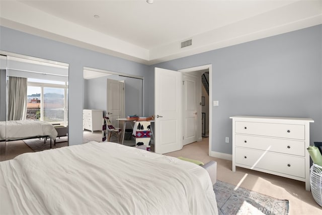 bedroom with light colored carpet and a closet