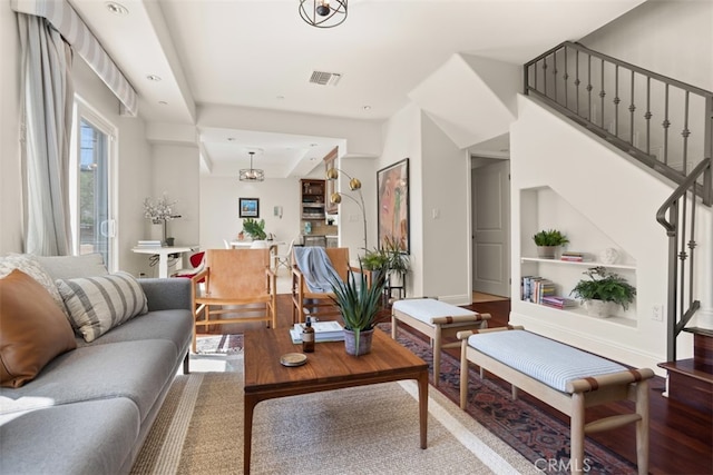 living room with a chandelier and wood-type flooring