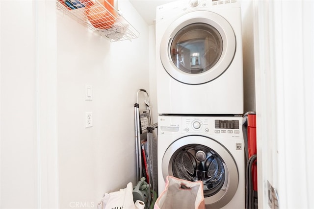 laundry area featuring stacked washer and clothes dryer