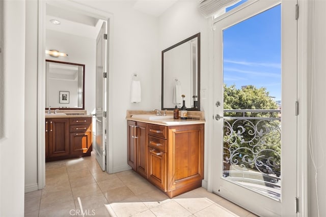 bathroom with tile patterned flooring, vanity, and a washtub