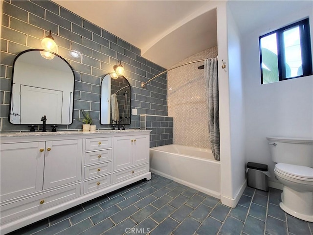 full bathroom featuring toilet, shower / bath combination with curtain, vanity, and vaulted ceiling