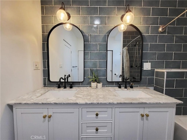 bathroom featuring vanity and tasteful backsplash