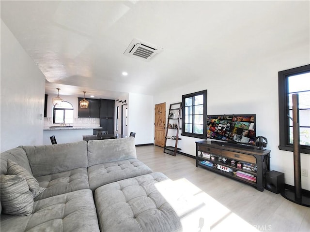 living room with light hardwood / wood-style flooring