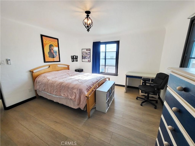 bedroom with hardwood / wood-style flooring