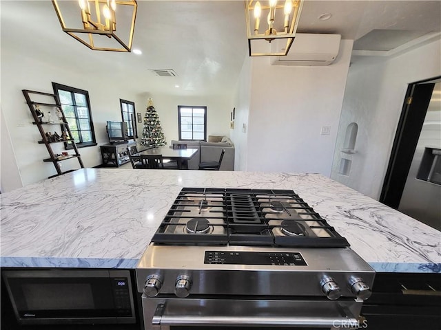 kitchen with a wall mounted air conditioner and stainless steel appliances