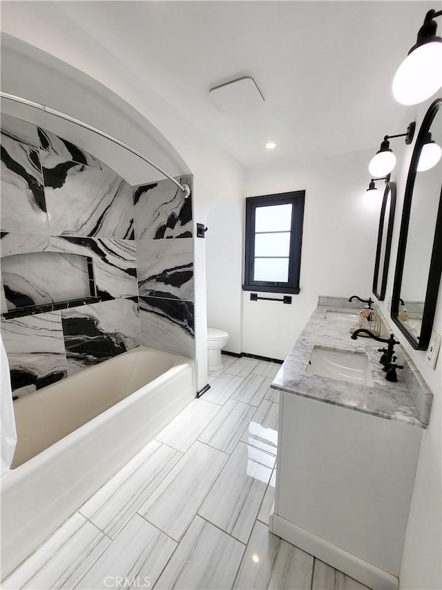 full bathroom featuring bathtub / shower combination, vanity, and toilet