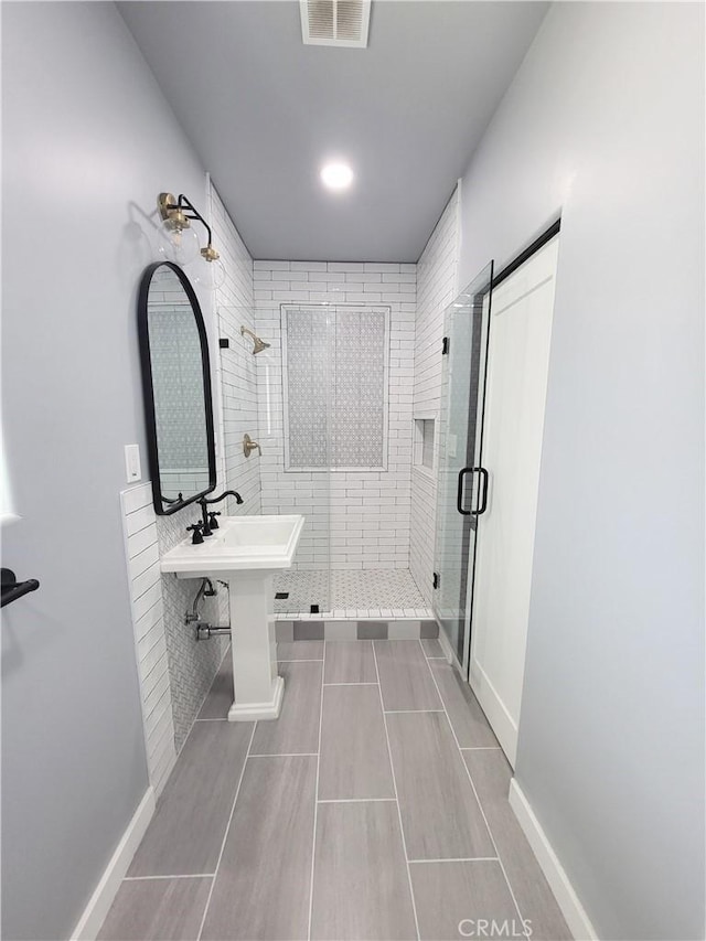 bathroom featuring tile patterned floors and an enclosed shower