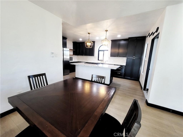 dining room featuring light hardwood / wood-style flooring and a chandelier