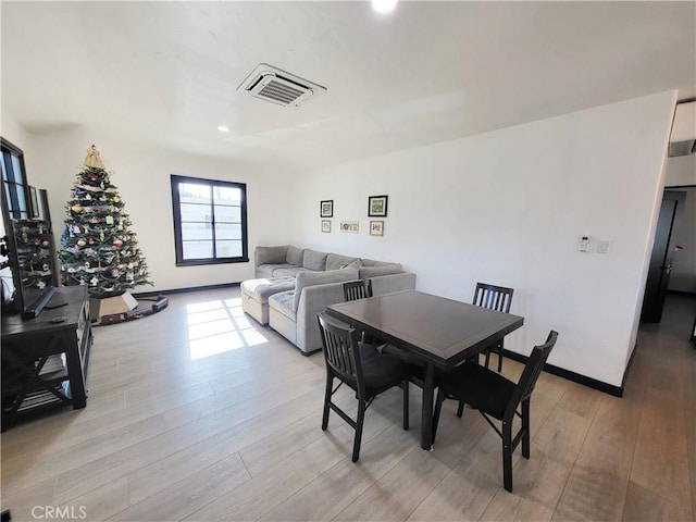 dining area with light hardwood / wood-style flooring