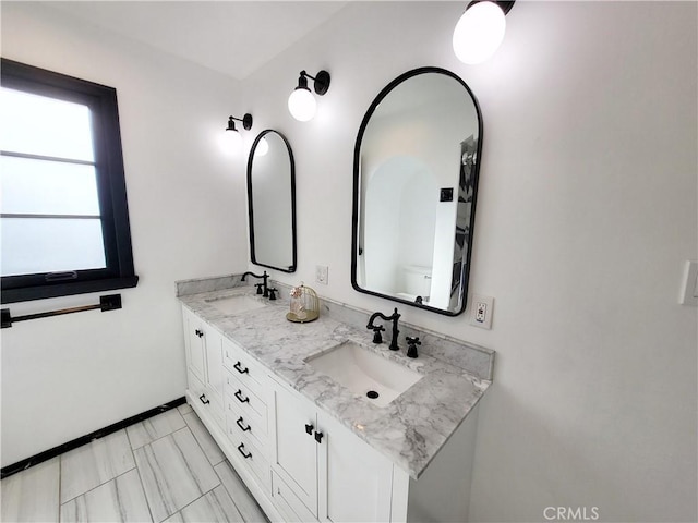 bathroom featuring vanity and toilet