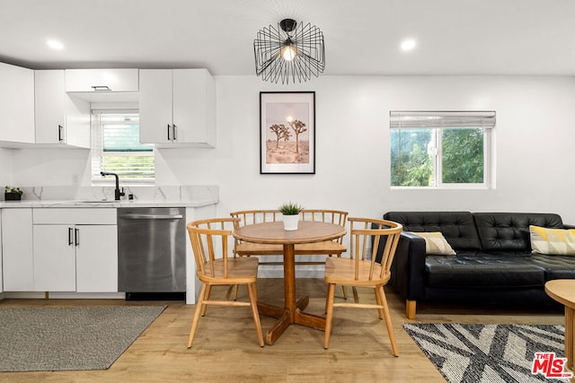 dining room featuring light hardwood / wood-style flooring and sink