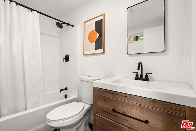 full bathroom featuring vanity, shower / bath combination with curtain, and toilet