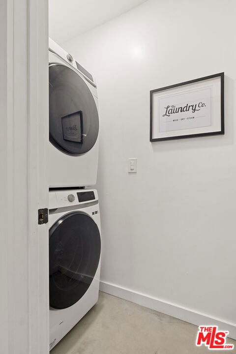 laundry room featuring stacked washer / dryer