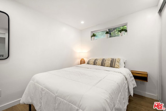 bedroom featuring dark hardwood / wood-style flooring