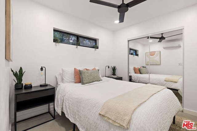 bedroom with a wall mounted AC, a closet, and ceiling fan