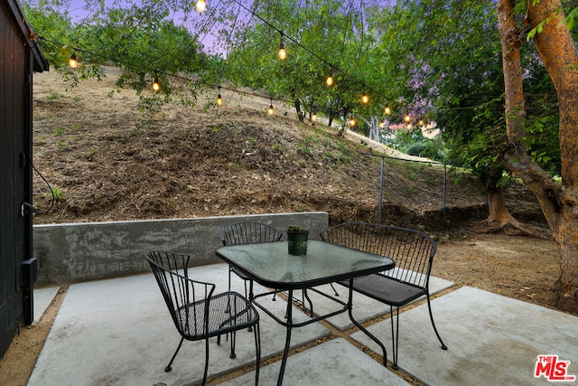 view of patio terrace at dusk